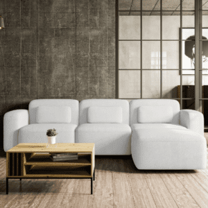 Niewielki narożnik w kolorze białym, ustawiony w stylowej aranżacji salonu, widok od frontu. Subtelny design, komfortowe siedzisko i delikatna forma podkreślają nowoczesny charakter wnętrza.